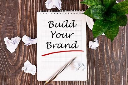 The word build your brand written on a paper
