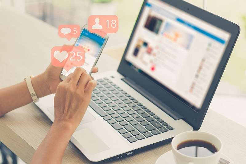 Young girl using Facebook on a phone