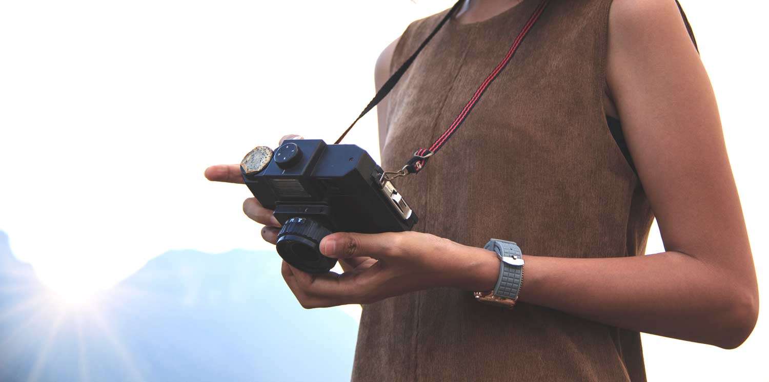 Creative girl holding a camera